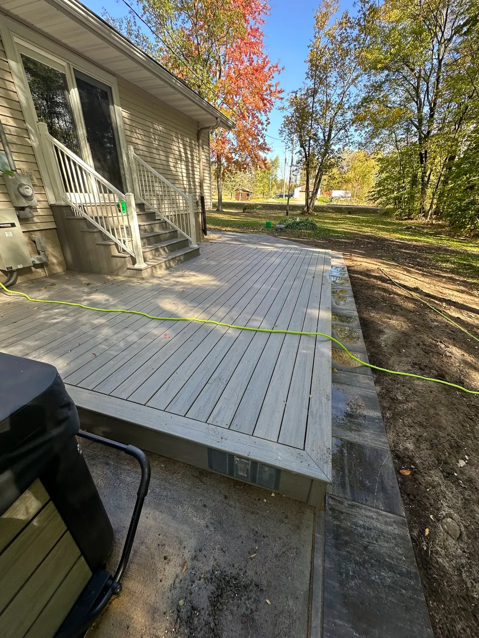 Low ground-level composite deck in a backyard